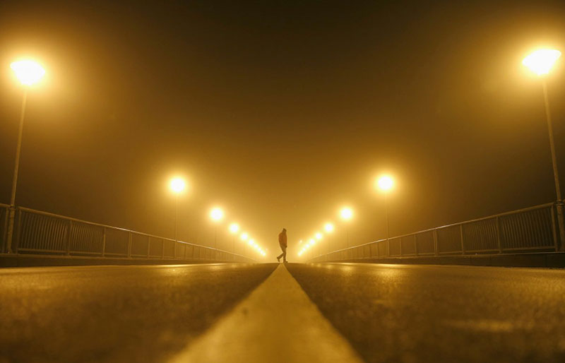 a-man-walks-on-the-street-during-heavy-smog-in-the-central-bosnian-town-of-zenica-early-november-19-2014