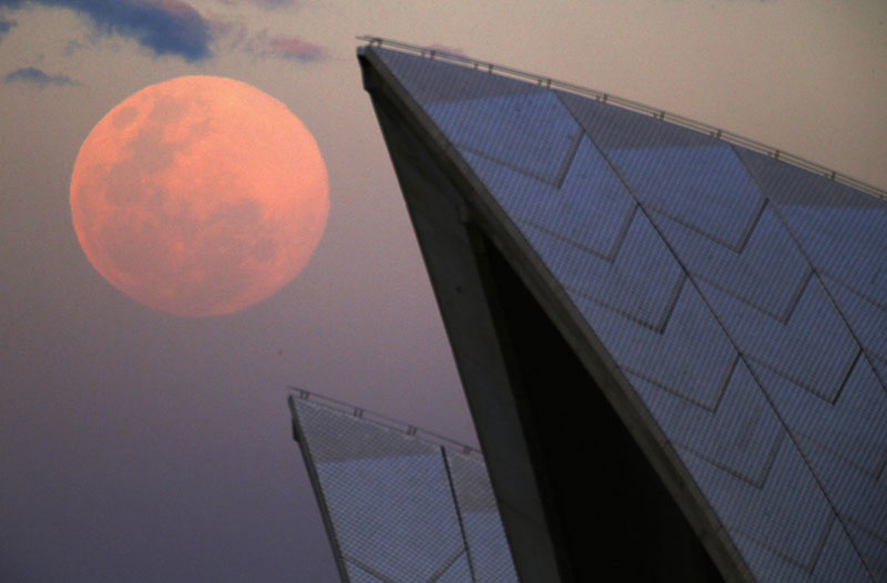 a-supermoon-rises-behind-the-roof-of-the-sydney-opera-house-august-10-2014-the-astronomical-event-occurs-when-the-moon-is-closest-to-earth-in-its-orbit-making-it-appear-much-larger-and-brighter-than-usual