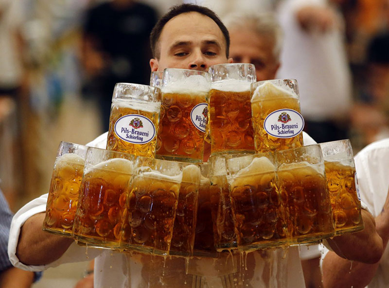 german-oliver-struempfl-competes-to-successfully-set-a-new-world-record-in-carrying-one-liter-beer-mugs-over-a-distance-of-over-131-feet-in-abensberg-germany-september-7-2014