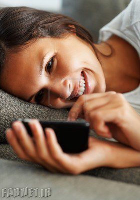 pretty-woman-lying-on-the-sofa-holding-her-smartphone